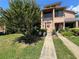Charming townhome featuring a welcoming front door, beautiful landscaping, and well-maintained walkway to entrance at 105 Wood Duck Cir # D, Daytona Beach, FL 32119