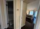 Hallway with hardwood floors, doors to the bedroom and bath, and a thermostat at 105 Wood Duck Cir # D, Daytona Beach, FL 32119
