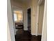 Hallway showcasing hardwood floors, with doors leading to the bedroom and bathroom at 105 Wood Duck Cir # D, Daytona Beach, FL 32119