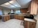 Well-lit kitchen featuring natural wood cabinetry, stainless steel appliances, and a skylight at 105 Wood Duck Cir # D, Daytona Beach, FL 32119