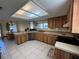 Well-lit kitchen featuring natural wood cabinetry, stainless steel appliances, and a skylight at 105 Wood Duck Cir # D, Daytona Beach, FL 32119