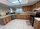 Well-lit kitchen featuring natural wood cabinetry, stainless steel appliances, and a skylight at 105 Wood Duck Cir # D, Daytona Beach, FL 32119