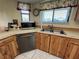 Kitchen featuring stainless steel appliances and wooden cabinets with a double basin sink at 105 Wood Duck Cir # D, Daytona Beach, FL 32119
