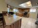 Well-lit kitchen featuring light counter tops, natural wood cabinets, and stainless steel appliances at 105 Wood Duck Cir # D, Daytona Beach, FL 32119