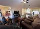 Comfortable living room featuring vaulted ceilings, wood floors, and a cozy seating arrangement at 105 Wood Duck Cir # D, Daytona Beach, FL 32119