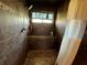 Modern walk-in shower with tiled walls, built-in bench, and updated fixtures at 105 Wood Duck Cir # D, Daytona Beach, FL 32119