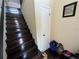 Elegant staircase with hardwood steps and a neutral-colored wall at 105 Wood Duck Cir # D, Daytona Beach, FL 32119
