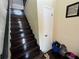 Elegant staircase with hardwood steps and a neutral-colored wall at 105 Wood Duck Cir # D, Daytona Beach, FL 32119