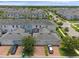 An aerial view of townhomes with brick driveways and attached garages, showcasing the community's layout and streetscape at 11812 Metaphor Aly, Orlando, FL 32832