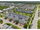 Aerial view of a community featuring well-kept lawns, townhomes, and garages at 11812 Metaphor Aly, Orlando, FL 32832