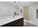 Bright bathroom with a single sink vanity, mirror, and bathtub with a floral shower curtain at 11812 Metaphor Aly, Orlando, FL 32832