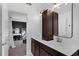 Bathroom boasts dual sinks and vanity with a view into a bedroom at 11812 Metaphor Aly, Orlando, FL 32832