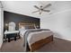 Comfortable bedroom featuring a wood bed frame, ceiling fan, and a stylish vanity with a stool at 11812 Metaphor Aly, Orlando, FL 32832