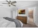 Cozy bedroom with ceiling fan, television, dresser, and an ensuite bathroom, offering both comfort and convenience at 11812 Metaphor Aly, Orlando, FL 32832