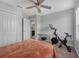 Bedroom features a stationary bike and a glimpse into an adjacent bathroom at 11812 Metaphor Aly, Orlando, FL 32832