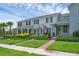 Inviting townhomes featuring well-manicured lawns, shrubbery, and charming brick walkways leading to the front doors at 11812 Metaphor Aly, Orlando, FL 32832