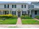 Inviting townhome featuring a well-manicured lawn and a charming brick pathway leading to the front door at 11812 Metaphor Aly, Orlando, FL 32832