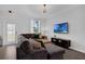 Comfortable living room with a large sectional sofa, neutral decor, and abundant natural light at 11812 Metaphor Aly, Orlando, FL 32832