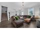 Bright living room with a comfortable sectional, leading to the stairway and dining area at 11812 Metaphor Aly, Orlando, FL 32832