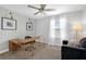 Stylish home office featuring neutral walls, modern lighting, a large desk and a comfortable chair at 11812 Metaphor Aly, Orlando, FL 32832