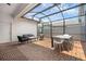 Enclosed patio with a brick floor, outdoor seating and dining area at 11812 Metaphor Aly, Orlando, FL 32832