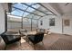 Enclosed brick patio with outdoor seating, rug, and overhead string lights at 11812 Metaphor Aly, Orlando, FL 32832