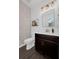 Stylish powder room with bold wallpaper and a dark vanity at 11812 Metaphor Aly, Orlando, FL 32832