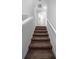 Carpeted staircase leading to the upper level, featuring neutral walls and white trim at 11812 Metaphor Aly, Orlando, FL 32832