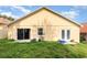 View of the backyard showing the sliding glass door and a door with windows at 1199 Stoneham Dr, Groveland, FL 34736