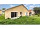 View of the backyard showing the sliding glass door and a door with windows at 1199 Stoneham Dr, Groveland, FL 34736
