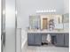 Large bathroom featuring double sinks, soaking tub, and walk-in shower at 1199 Stoneham Dr, Groveland, FL 34736