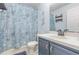 Cozy bathroom featuring nautical themed shower curtain and blue vanity at 1199 Stoneham Dr, Groveland, FL 34736