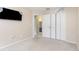 A spare bedroom with a closet, tv, and graffiti at 1199 Stoneham Dr, Groveland, FL 34736