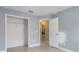 A spare bedroom with a closet and open door at 1199 Stoneham Dr, Groveland, FL 34736