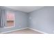 A spare bedroom with a window and beige tile at 1199 Stoneham Dr, Groveland, FL 34736