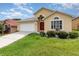 Lovely one-story home boasting a well-maintained lawn and an attached garage at 1199 Stoneham Dr, Groveland, FL 34736