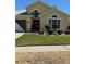 Charming one-story home featuring lush lawn and manicured landscaping at 1199 Stoneham Dr, Groveland, FL 34736