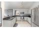 Bright kitchen featuring stainless steel appliances and sleek granite countertops at 1199 Stoneham Dr, Groveland, FL 34736
