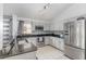 Modern kitchen featuring stainless steel appliances, granite countertops, and tiled floor at 1199 Stoneham Dr, Groveland, FL 34736