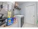This is a laundry room with a washer and dryer and some laundry supplies at 1199 Stoneham Dr, Groveland, FL 34736