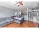 Comfortable living room with hardwood floors, ceiling fan, and access to kitchen at 1199 Stoneham Dr, Groveland, FL 34736
