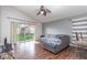 Comfortable living area with hardwood floors, ceiling fan, and sliding glass doors at 1199 Stoneham Dr, Groveland, FL 34736