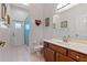 Well-lit bathroom with a shower, toilet, sink with vanity, and neutral tile floors at 12207 Shadowbrook Ln, Orlando, FL 32828