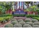 Entrance to the Sabal Isles community with lush landscaping and palm trees at 12207 Shadowbrook Ln, Orlando, FL 32828