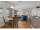 Open floor plan with dining area flowing into living room and offering casual seating at kitchen bar at 12207 Shadowbrook Ln, Orlando, FL 32828