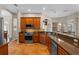 Spacious kitchen showcasing wood cabinets, granite countertops, stainless steel appliances, and tiled floors at 12207 Shadowbrook Ln, Orlando, FL 32828