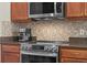 Well-equipped kitchen featuring a stainless steel oven, stylish backsplash, and ample counter space at 12207 Shadowbrook Ln, Orlando, FL 32828