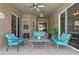 Inviting covered patio with comfortable seating, ceiling fan, and seamless indoor-outdoor living at 12207 Shadowbrook Ln, Orlando, FL 32828