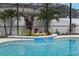 Close-up of the in-ground pool with attached spa and beautiful landscaping at 12207 Shadowbrook Ln, Orlando, FL 32828