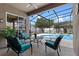 Relax on the patio with a view of the refreshing screened-in pool and lush landscaping at 12207 Shadowbrook Ln, Orlando, FL 32828